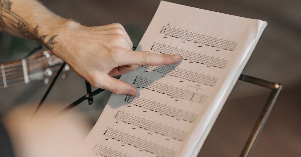 Close-up of a musician pointing at guitar sheet music on a stand indoors.